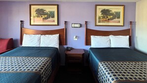 A hotel room with two beds, each with a wooden headboard, a nightstand, a telephone, and two framed pictures on the wall. - Royal Inn Linden (Linden)