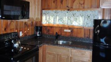 Full-size fridge, microwave, coffee/tea maker, cookware/dishes/utensils