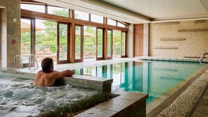 A man relaxing in a hot tub with a view of an outdoor patio area. - The Lodge at Primland, Auberge Collection (Meadows Of Dan)