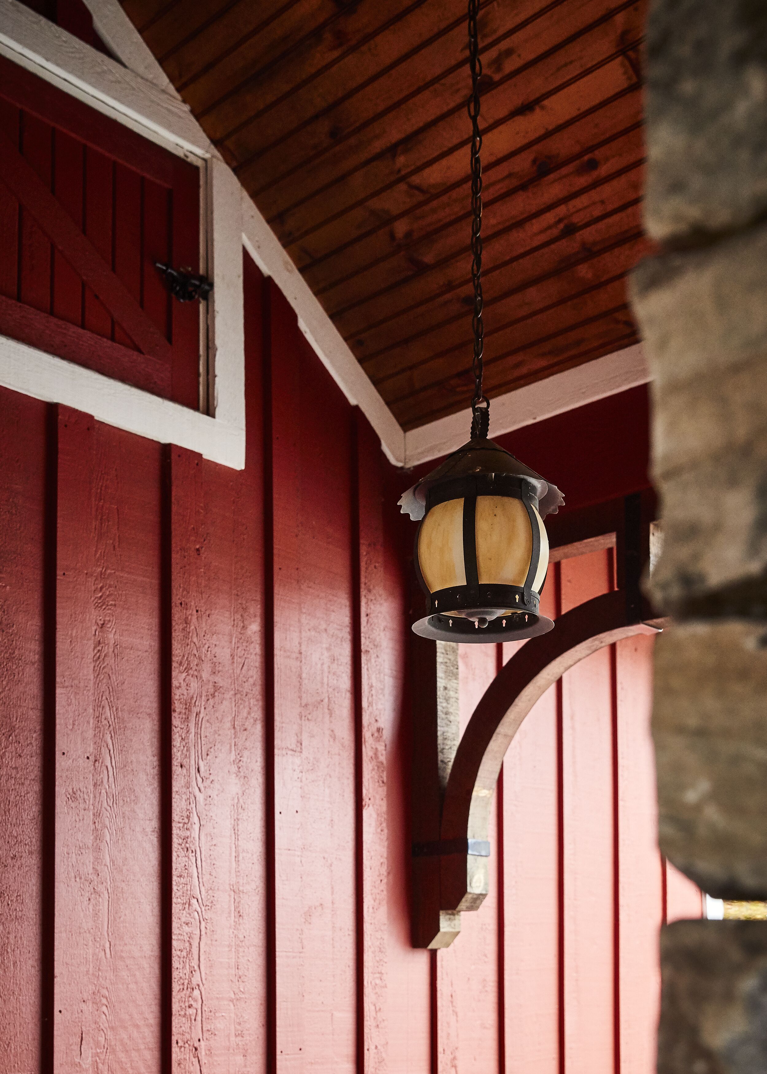 A red wooden structure with a hanging lantern.
