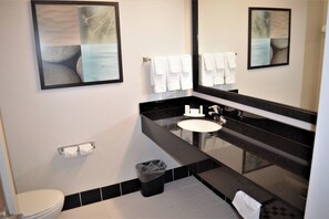 A modern bathroom with a black countertop sink, a large mirror, and a toilet. - Fairfield Inn & Suites by Marriott Sault Ste. Marie (Sault Ste. Marie)