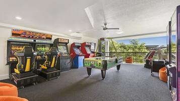 Enjoy games and relaxation in this vibrant space, featuring a pool table and arcade games.