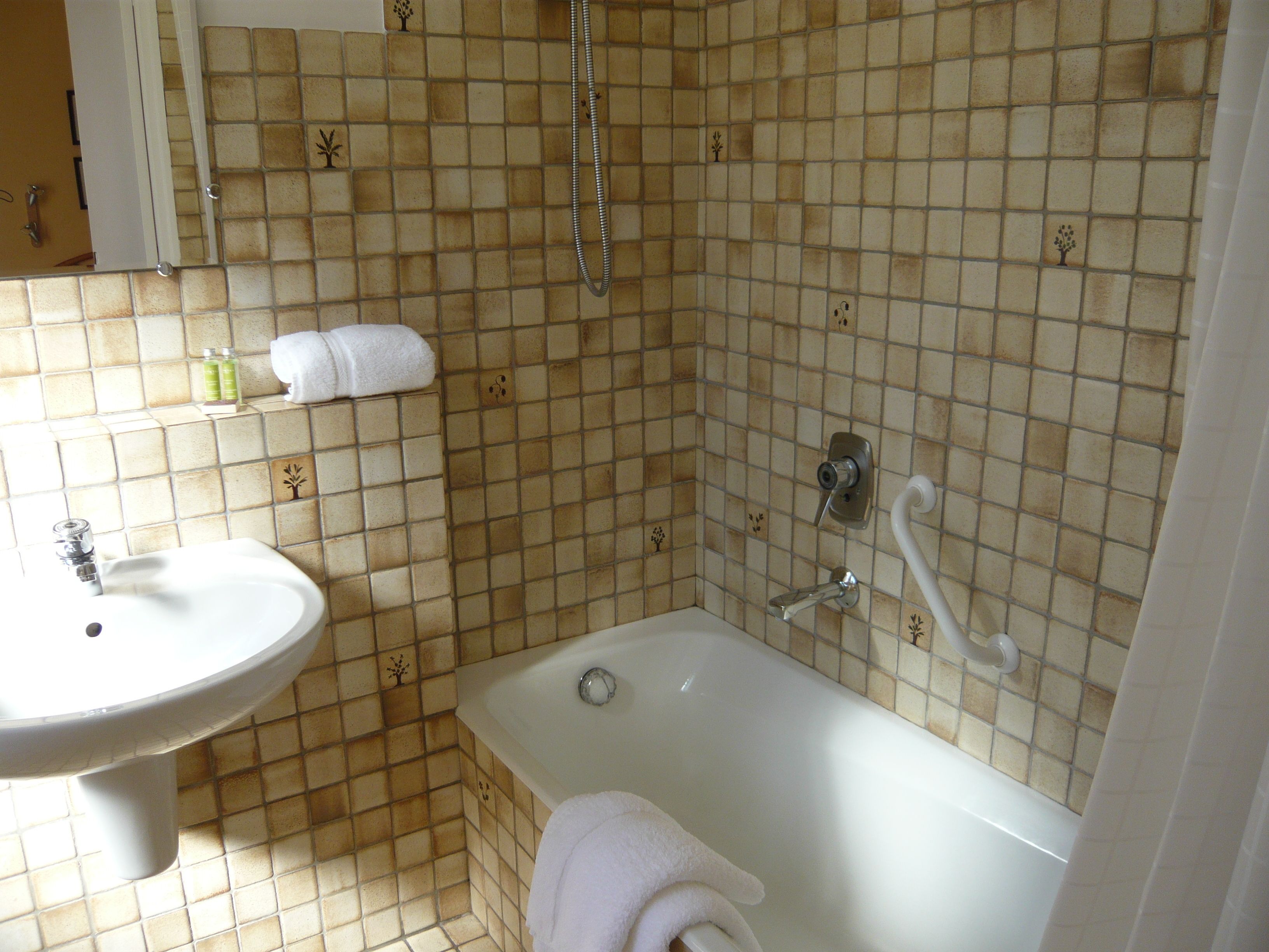 A bathroom with a sink, bathtub, and shower.