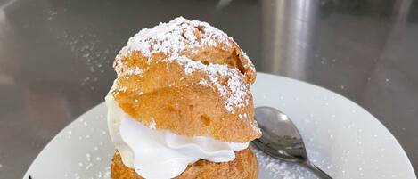 A dessert on a plate with powdered sugar.