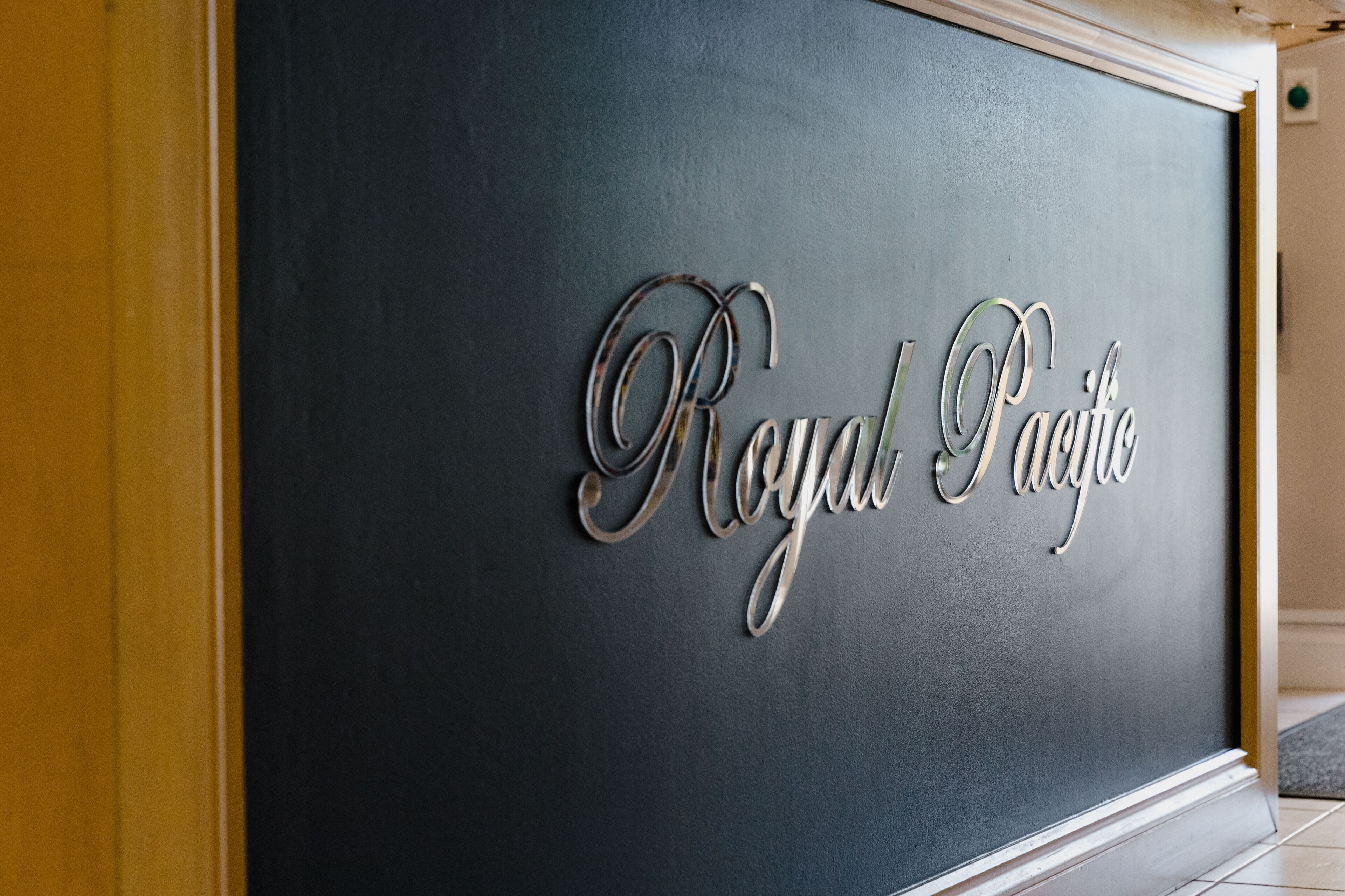 A wall with the text "Royal Pacific" in a decorative font.
