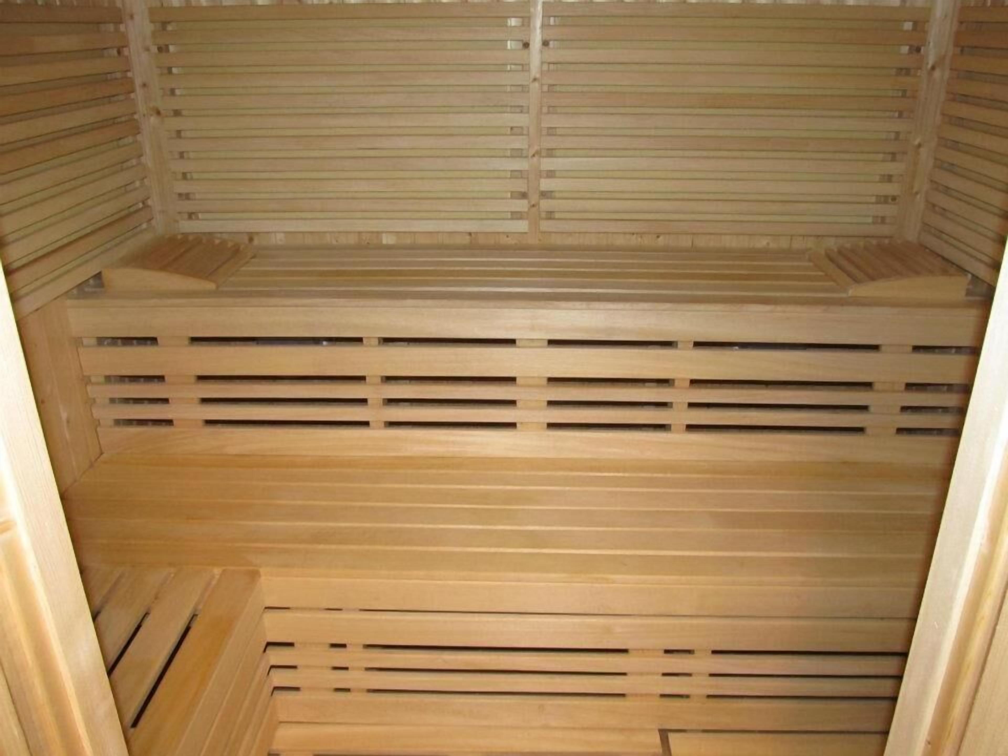 A sauna with wooden benches and slatted walls.