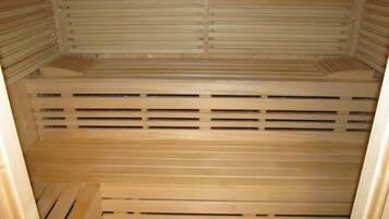 A sauna with wooden benches and slatted walls.