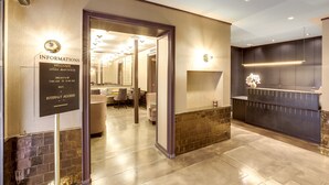 A hotel reception area with a signboard providing information about breakfast hours and internet access. - Hotel Opéra Maintenon (Paris)