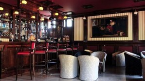 A bar area with wooden furniture, a bar counter, and a painting on the wall. - Coroana Brasovului (Brasov)