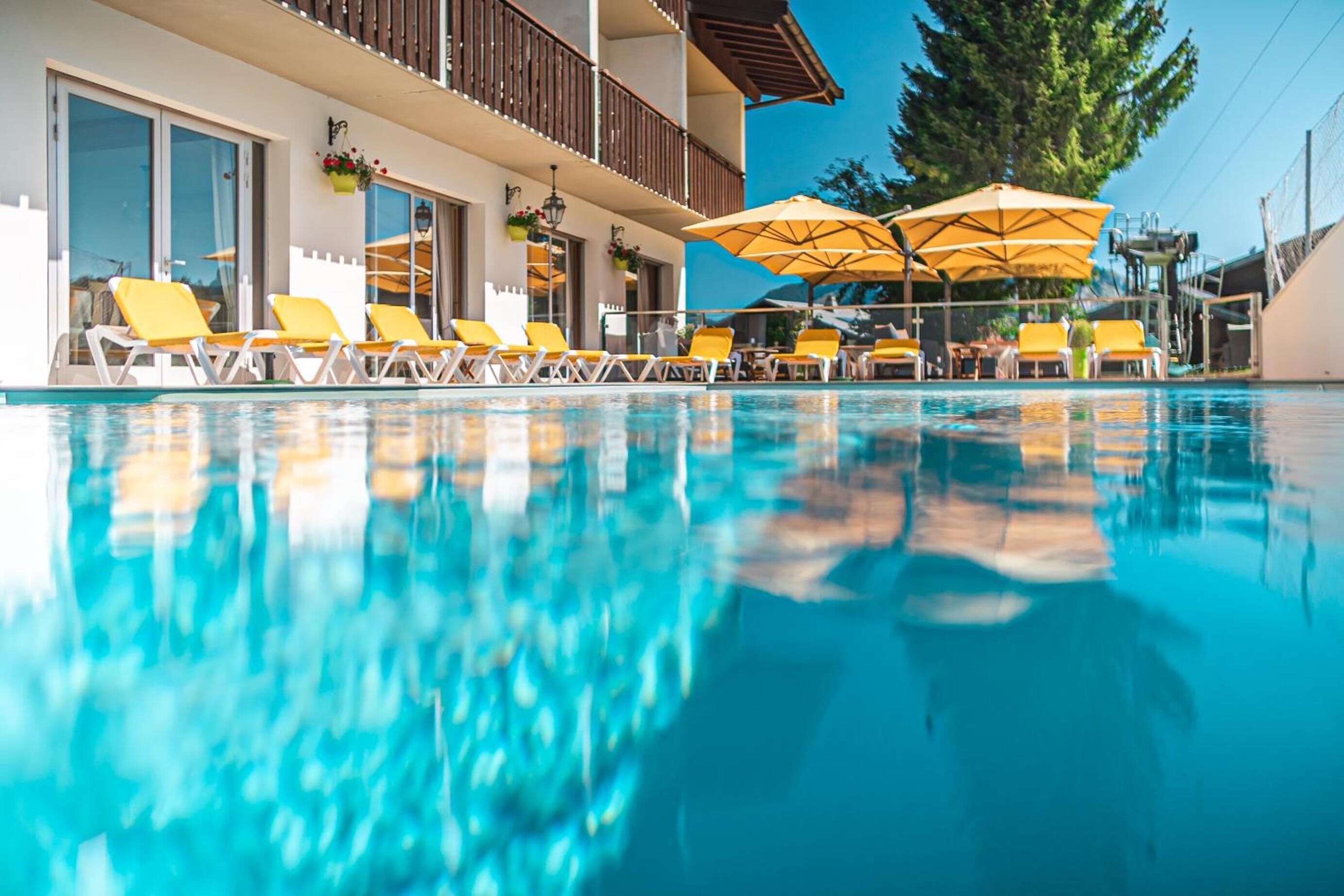 seasonal outdoor pool, pool umbrellas, pool loungers