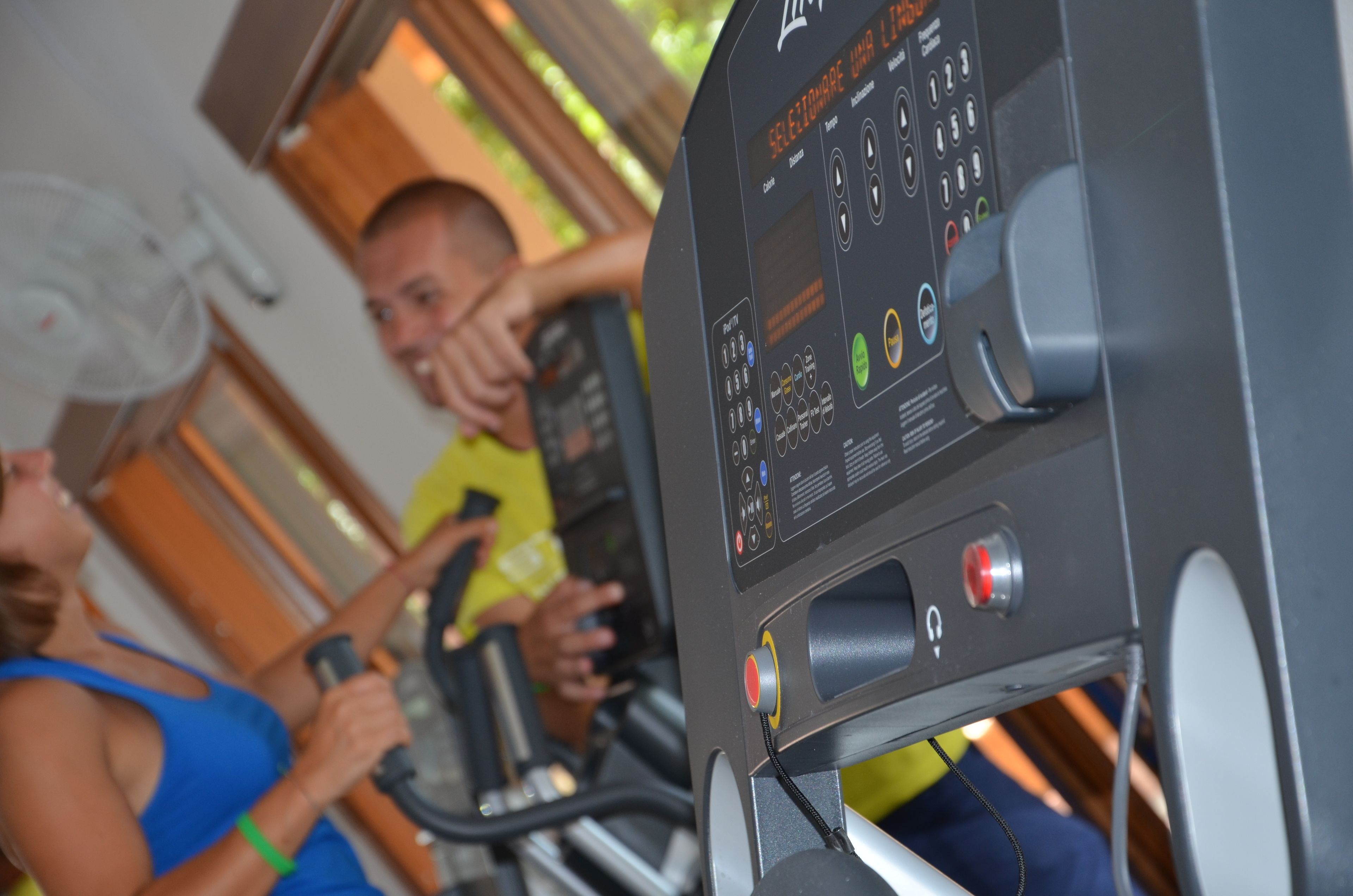 A gym with exercise equipment and a digital display.