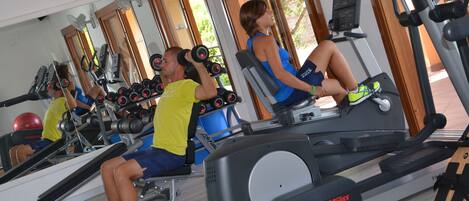 A gym with cardio machines and weightlifting equipment.