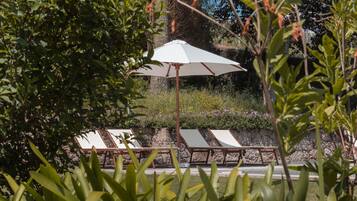 Una piscina al aire libre, tumbonas