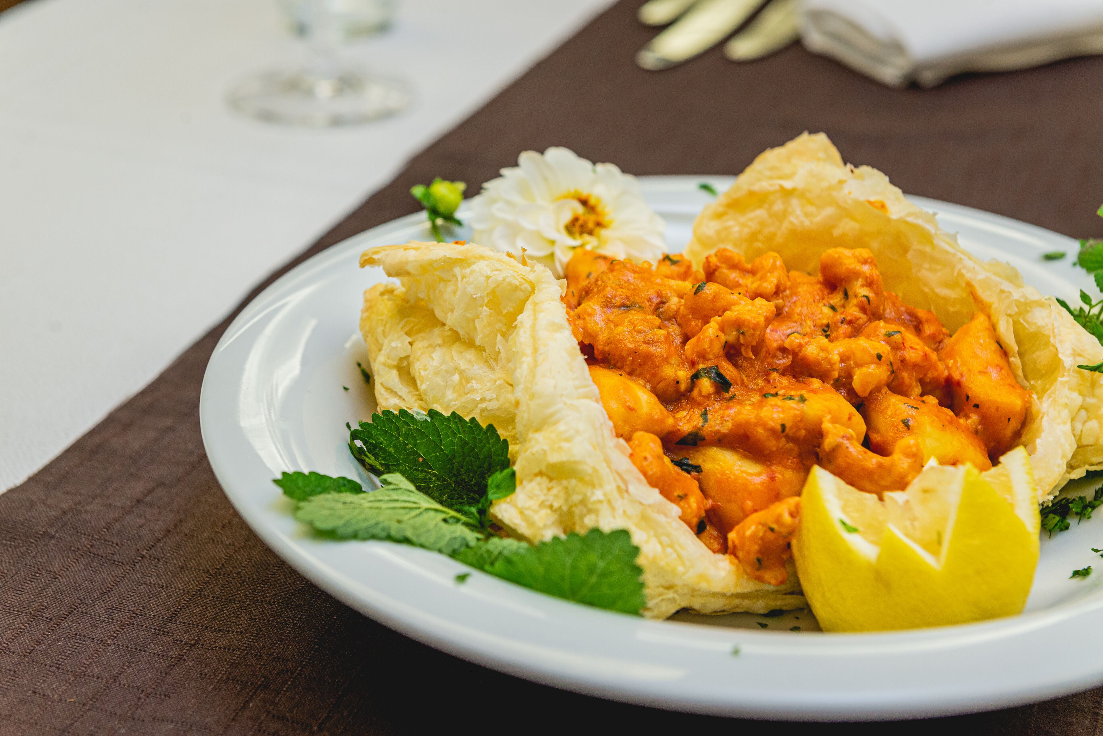 A plate of food with a lemon wedge and parsley garnish.