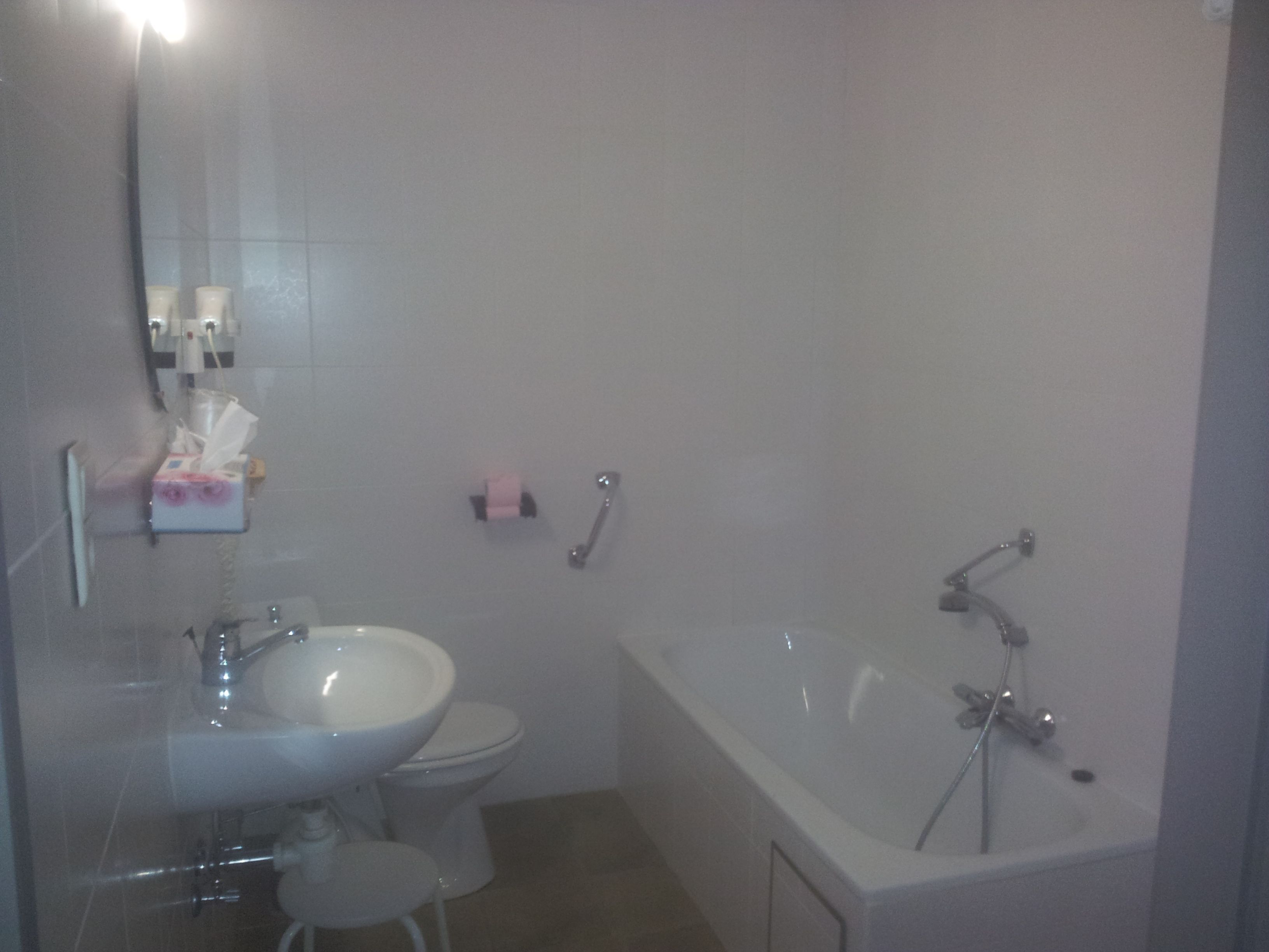A bathroom with a sink, toilet, and bathtub.