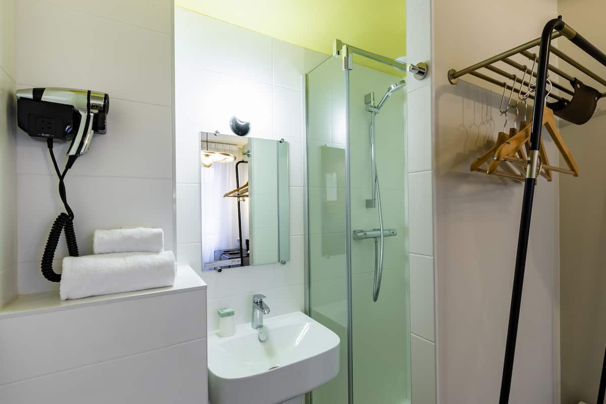 small single room | bathroom | hair dryer, towels