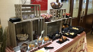 A breakfast buffet with various food items and condiments.