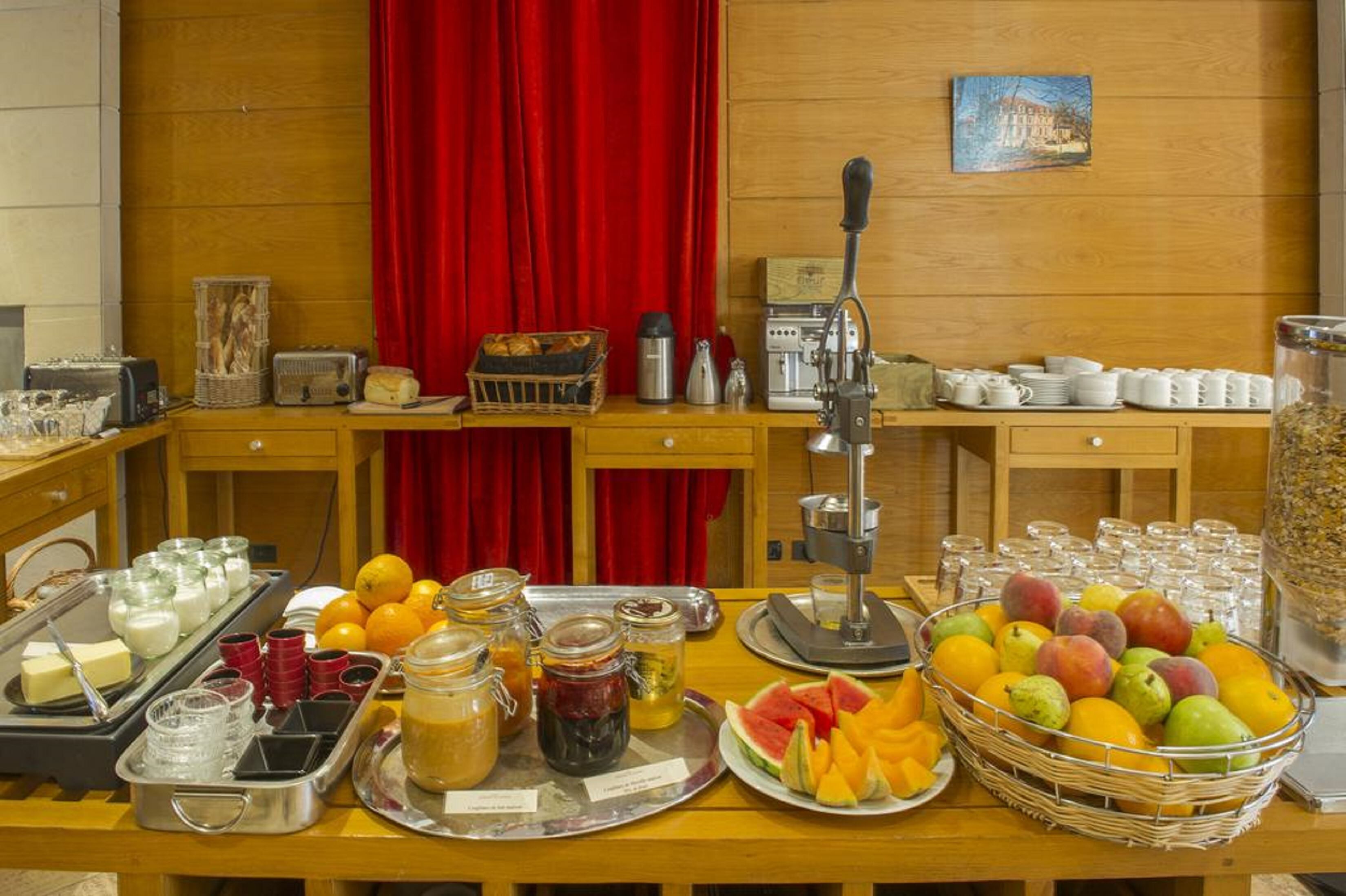 A breakfast buffet setup with various food items and beverages.