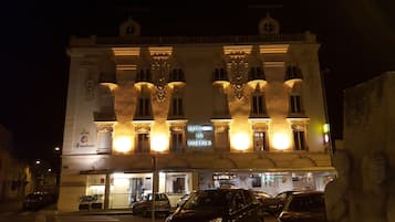 Vista frontal de la propiedad por la tarde o noche