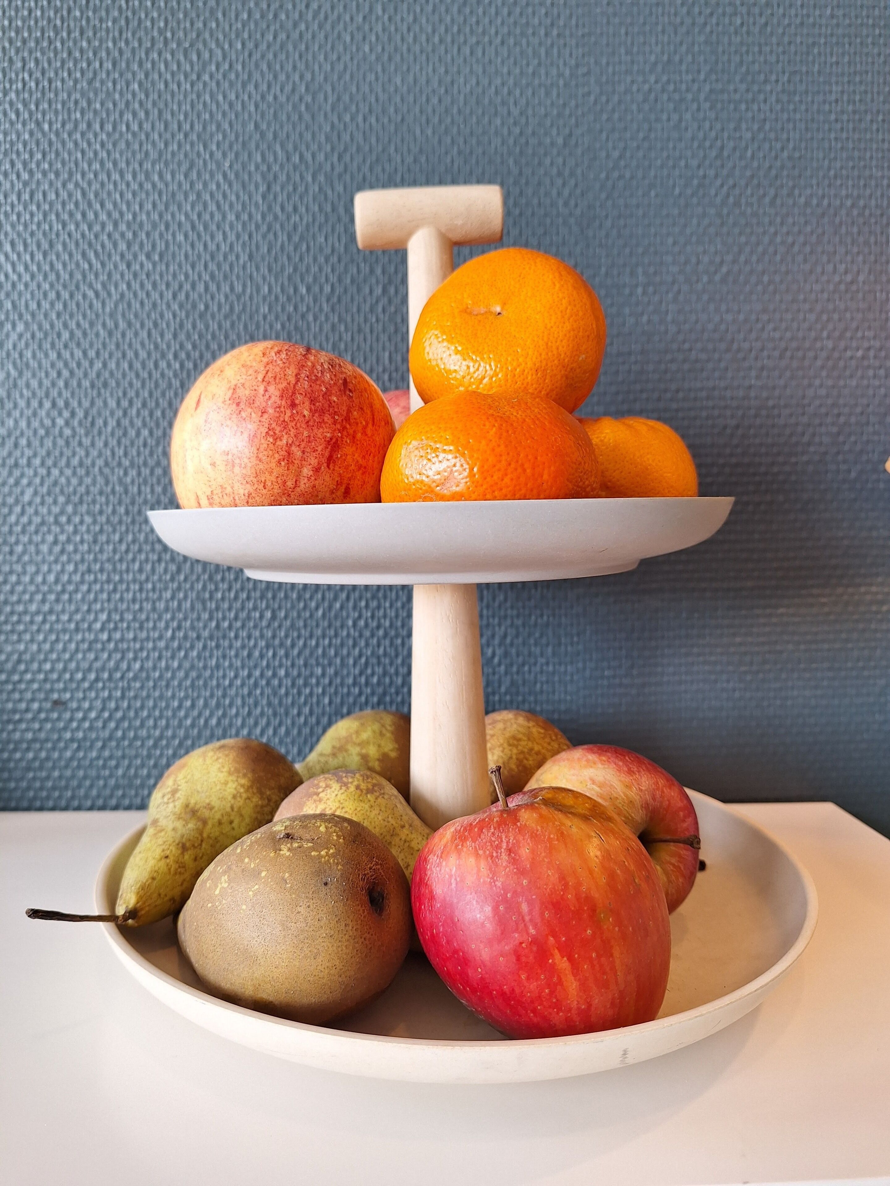 A fruit stand with apples, oranges, and pears.
