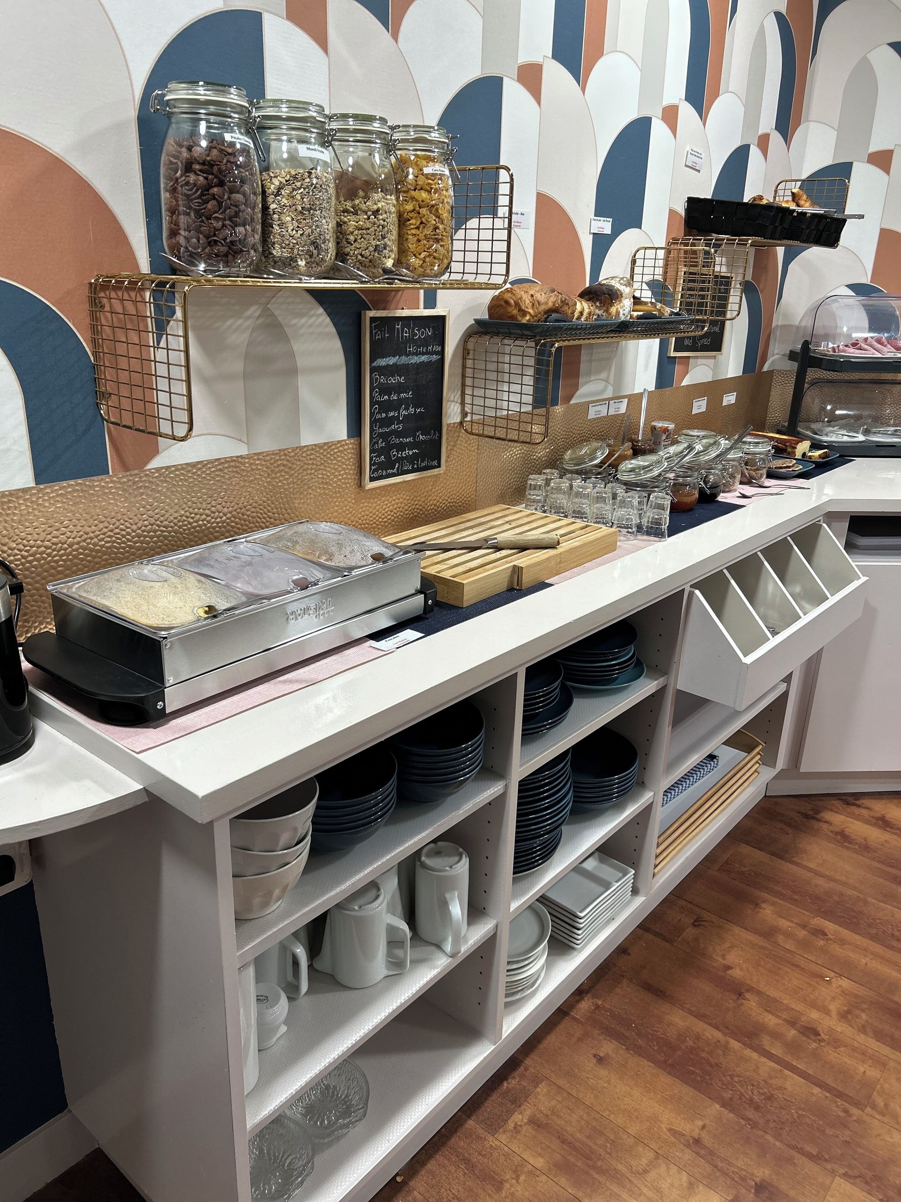 A breakfast buffet area with various food items and condiments.