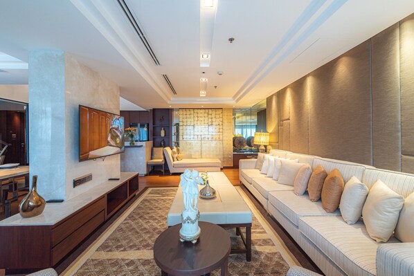 A modern living room with a sofa, coffee table, and TV.