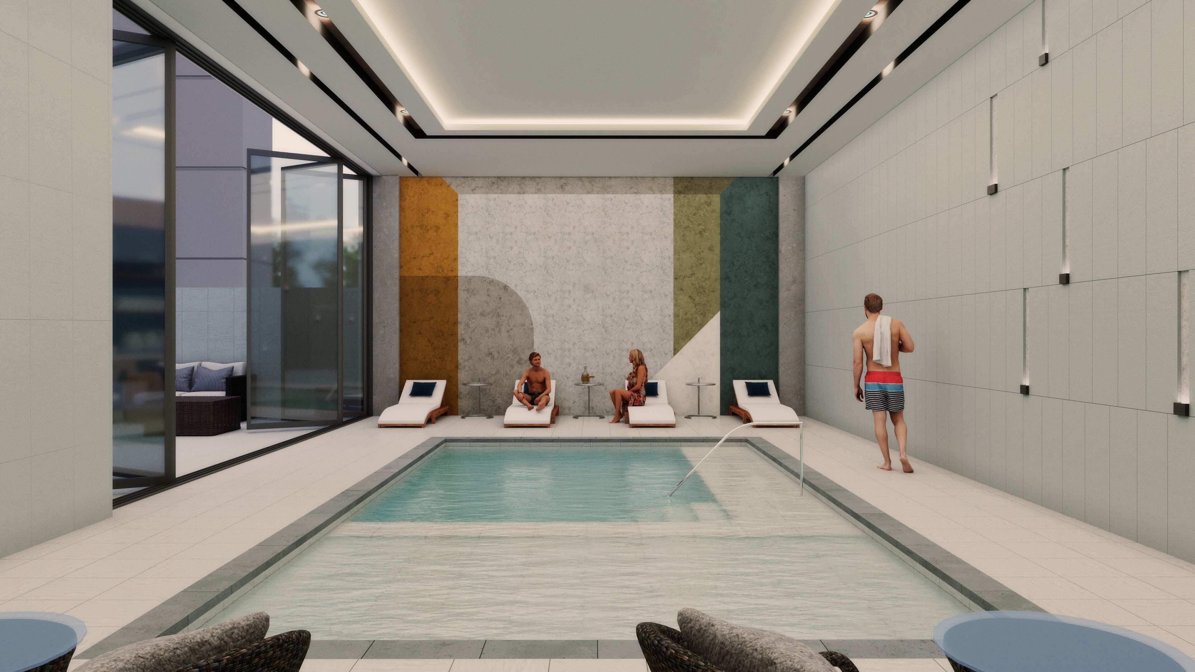 Un área de piscina interior moderna con sillones de descanso y piso de baldosas.