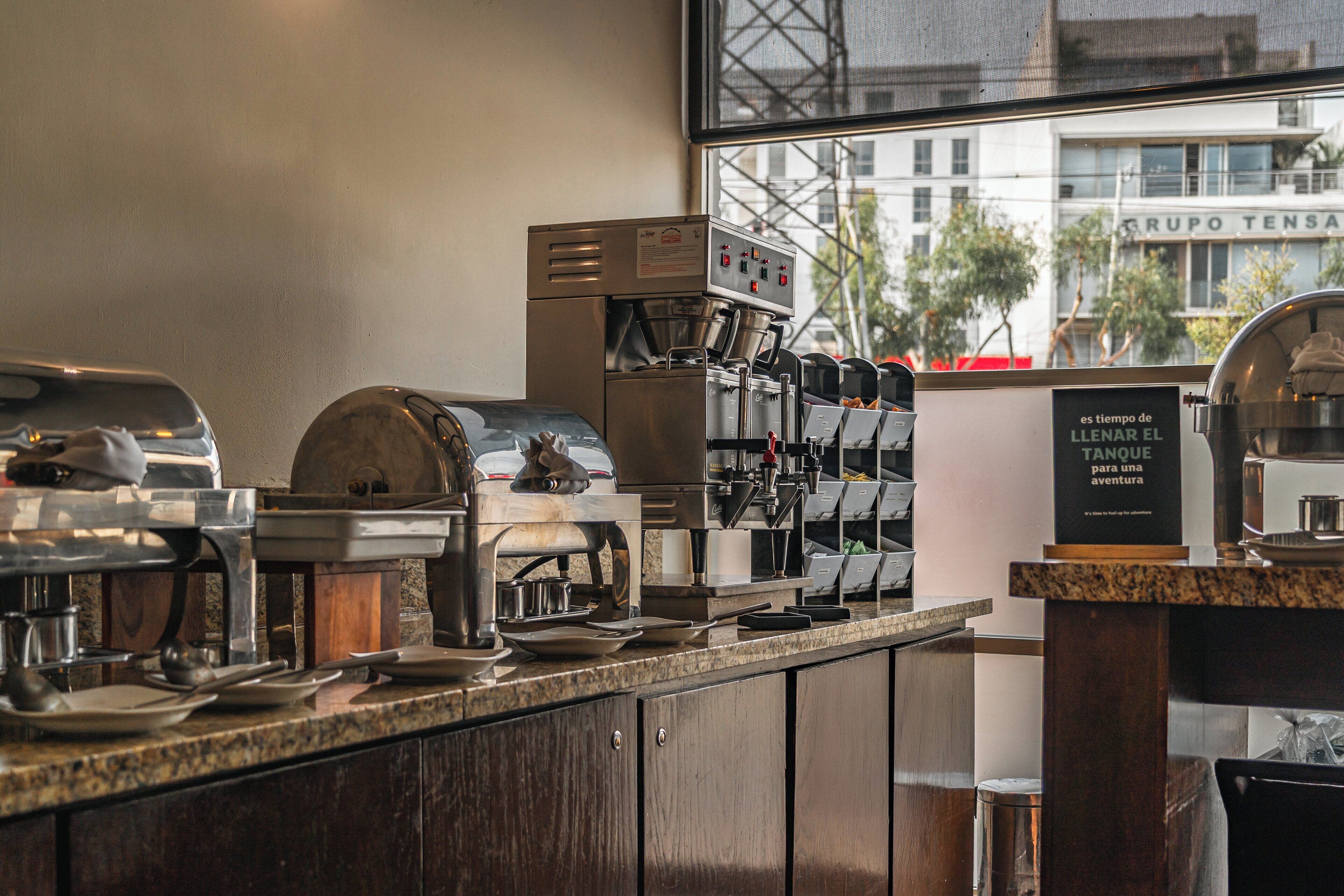 A coffee machine and various kitchen equipment in a cafe.