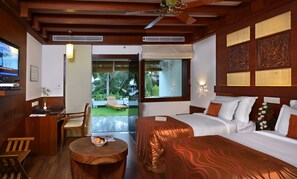 Relax in a stylish room with a large bed, desk, and garden view.