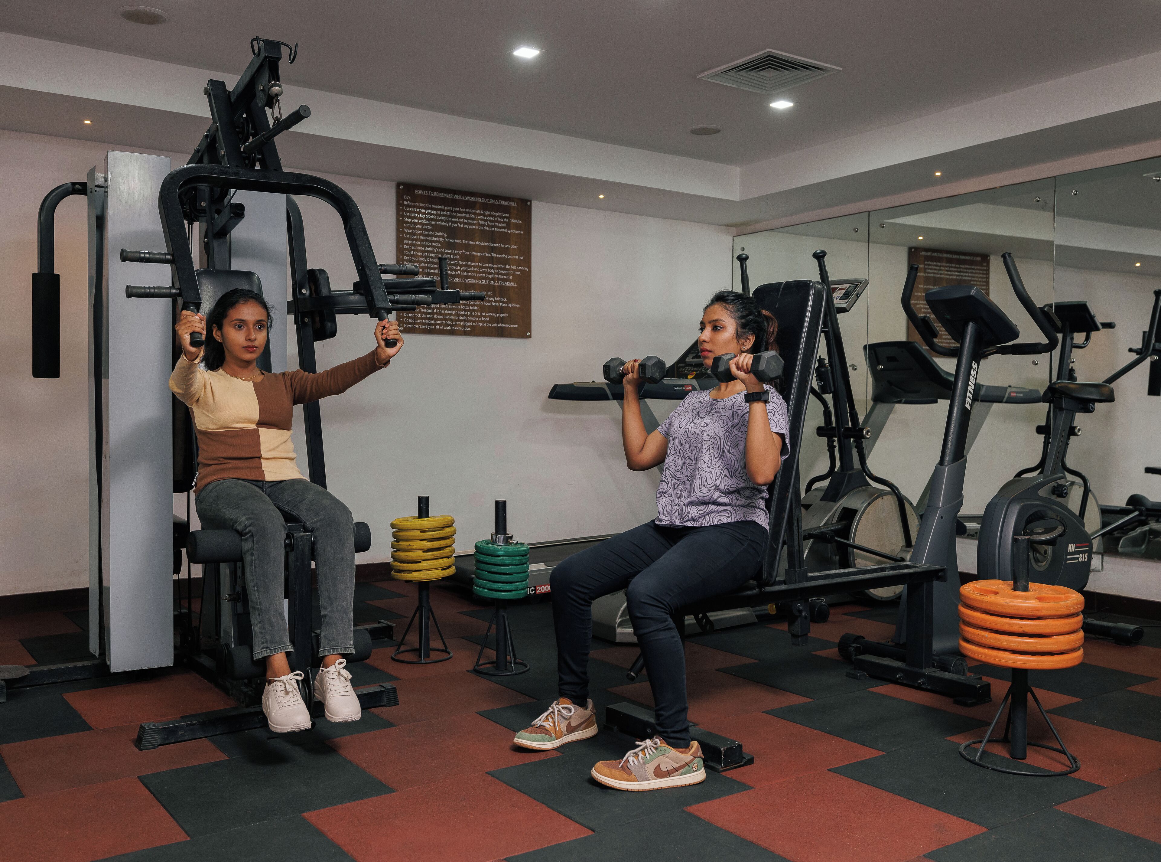 A gym with exercise equipment, including a weight bench and a treadmill.