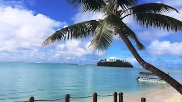 On the beach, white sand, sun loungers, beach towels