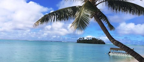 On the beach, white sand, sun loungers, beach towels