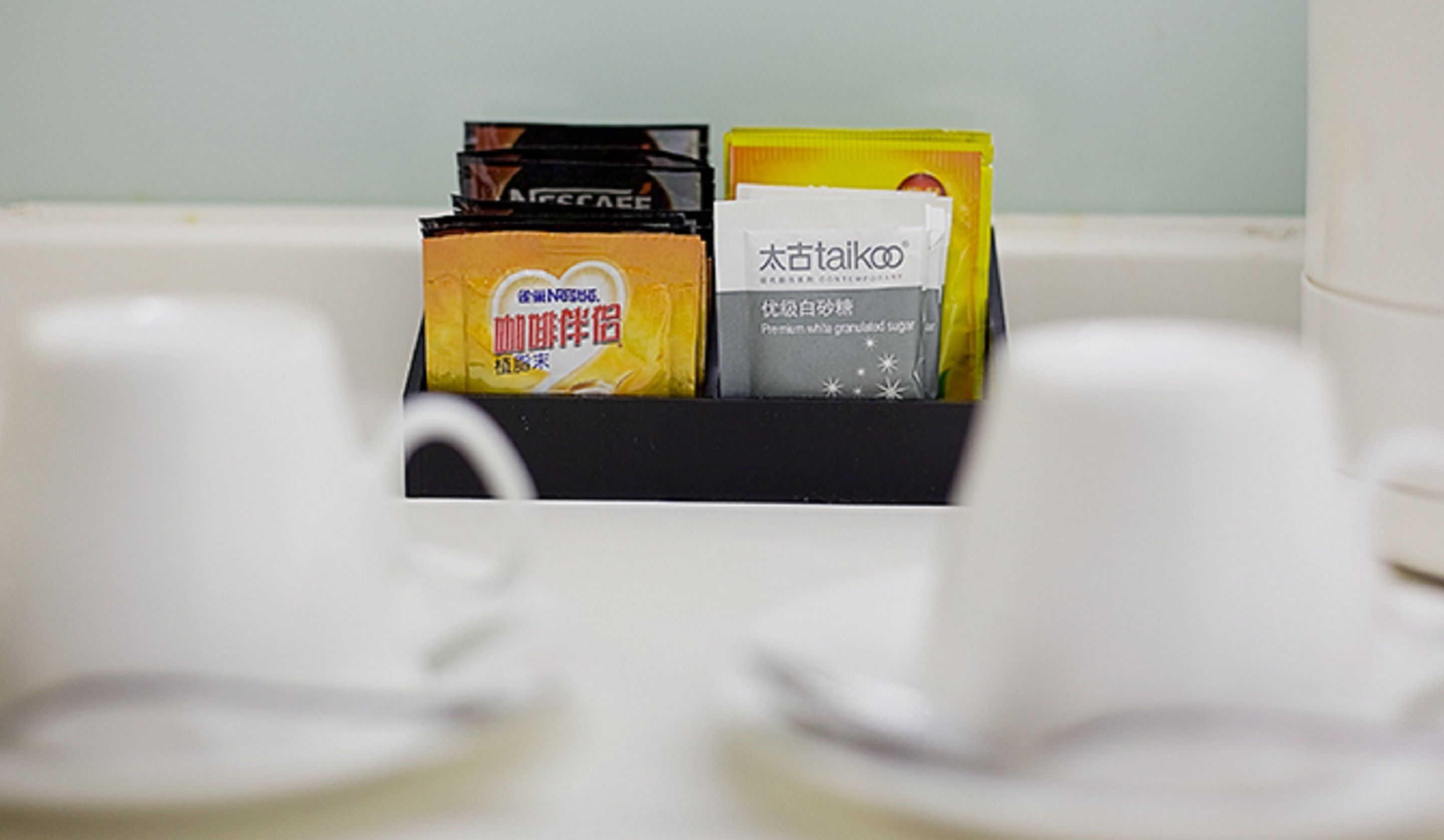 A coffee maker with a coffee pod holder containing two coffee pods.