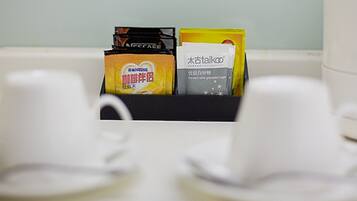 A coffee maker with a coffee pod holder containing two coffee pods.