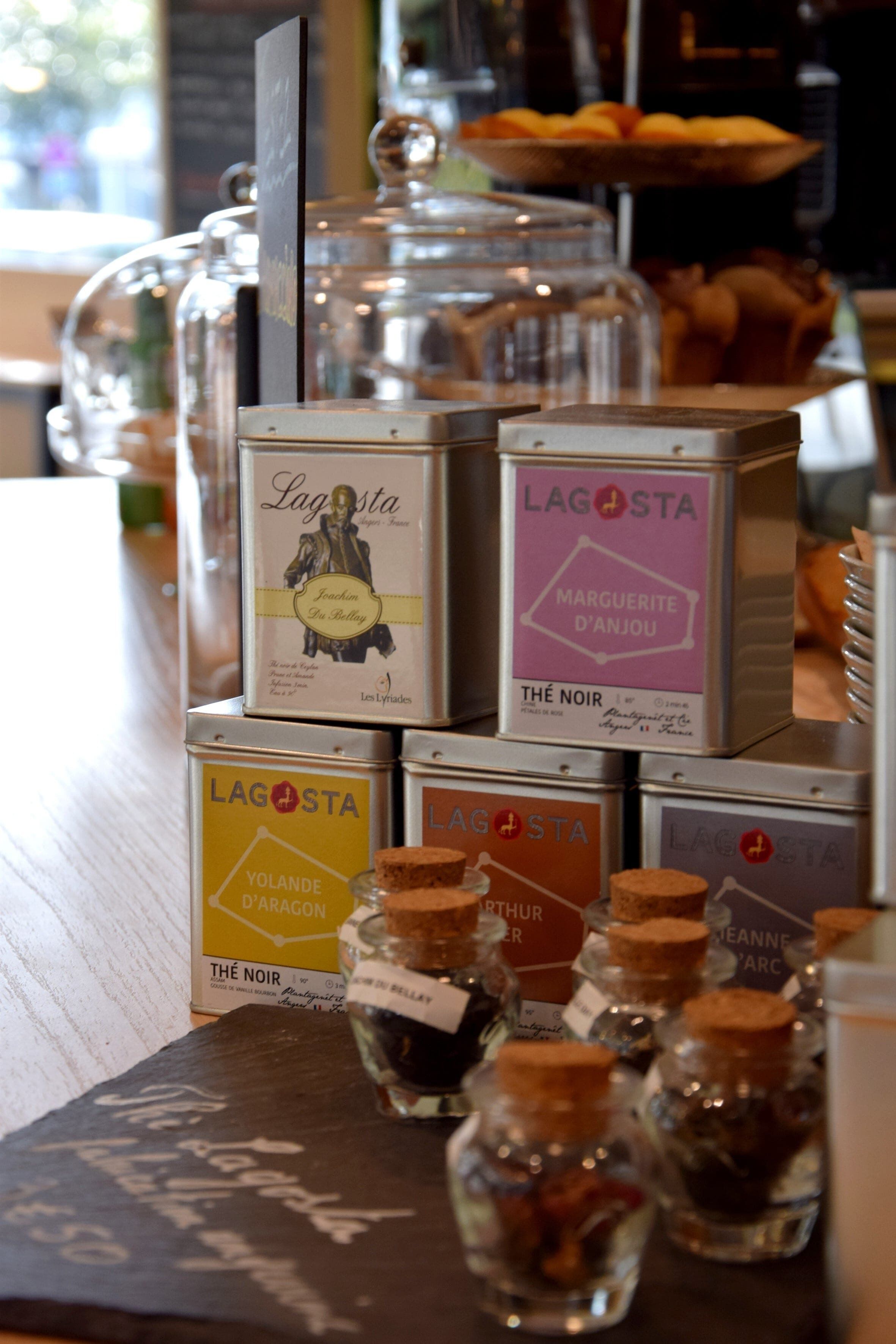 A display of Lagostina wine boxes and small bottles on a wooden surface.