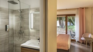 Une salle de bain moderne avec une douche, une baignoire et une grande fenêtre.