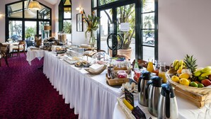 A buffet setup with various food items, a coffee station, and a fruit basket. - Excelsior (Saint-Raphael)