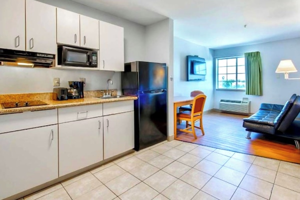 Coffee/tea maker, fridge, microwave, dining table