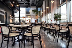 A spacious cafe with high ceilings, large windows, and modern furniture. - Thon Hotel Kungsbron (Stockholm)