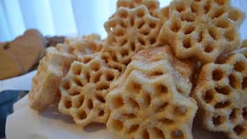 A stack of honeycomb waffles on a white napkin.