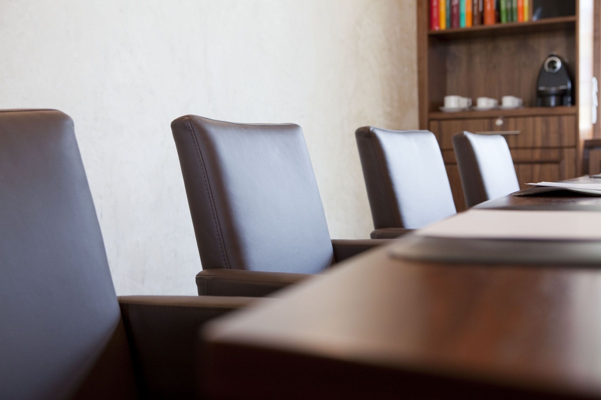 A conference room with a long table and several chairs.