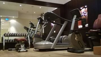 A gym with various exercise machines, including treadmills and elliptical trainers.