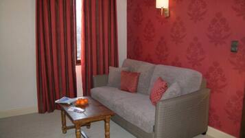 Quadruple Room | Living area | 66-cm flat-screen TV with digital channels