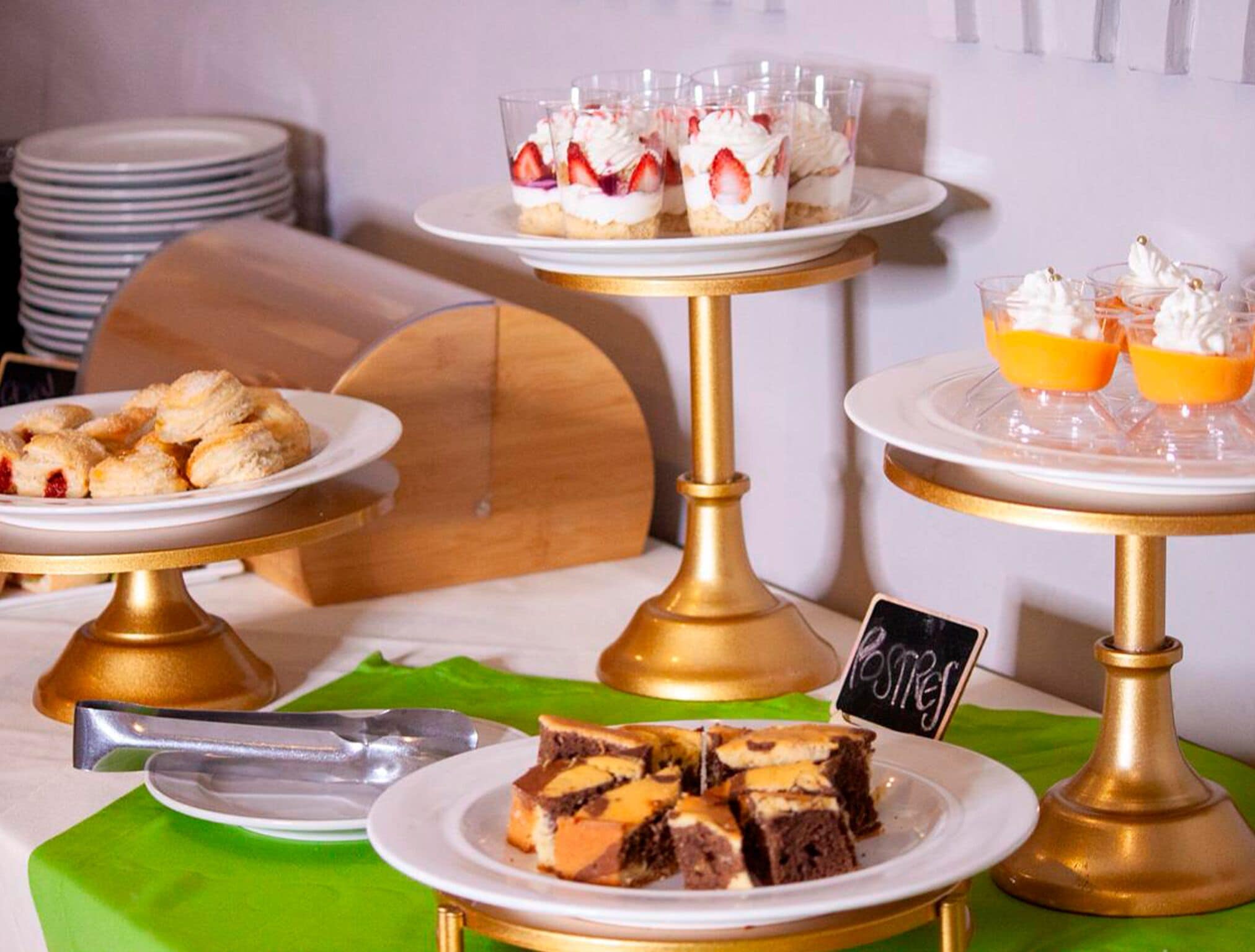 A buffet setup with multiple serving platters, including desserts and beverages.