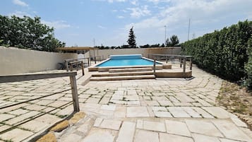 Seasonal outdoor pool, pool umbrellas, pool loungers
