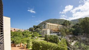 Ein Hotel mit Innenhof, umgeben von Grünflächen und Hügeln.