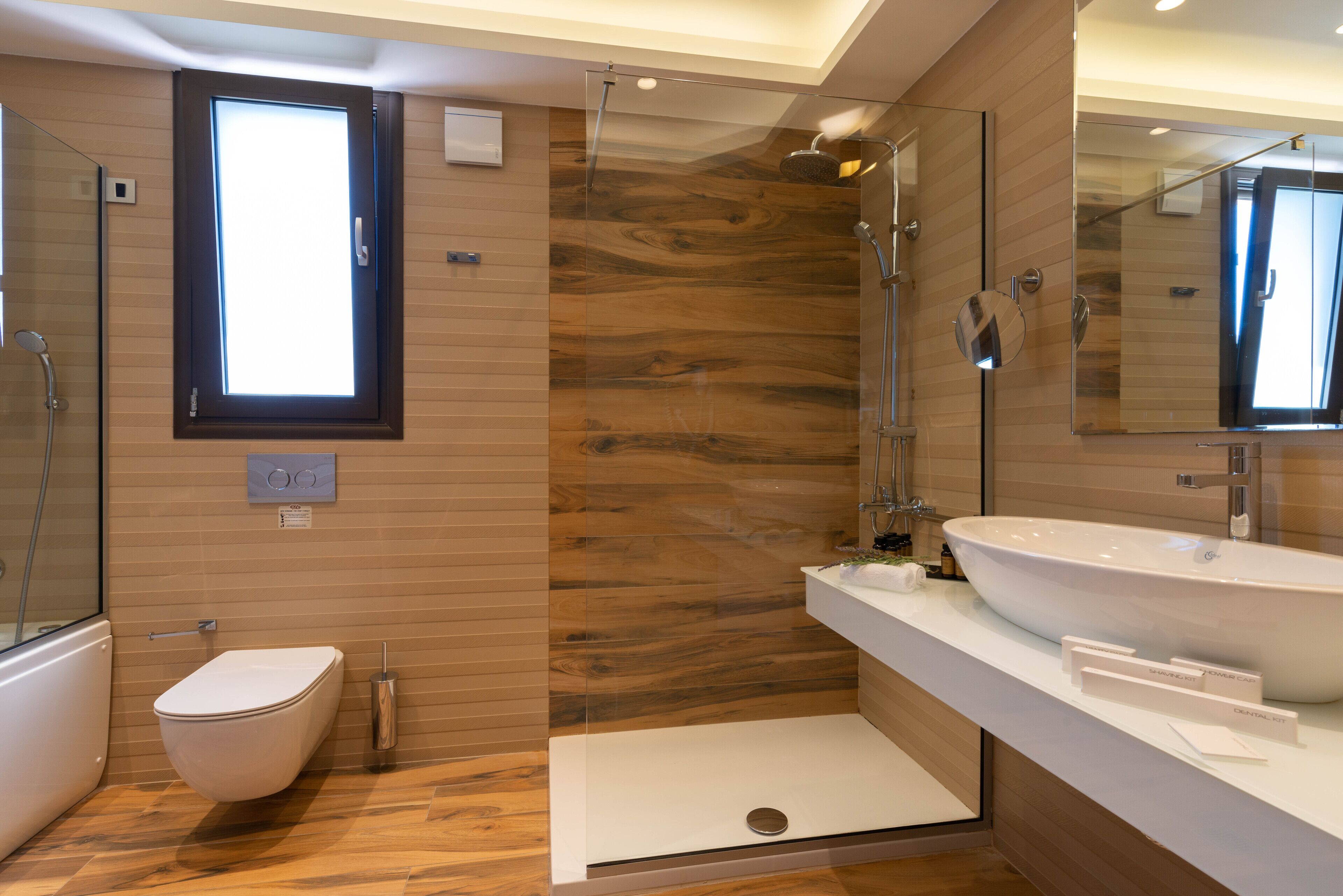 A modern bathroom with a walk-in shower, a toilet, and a large sink.