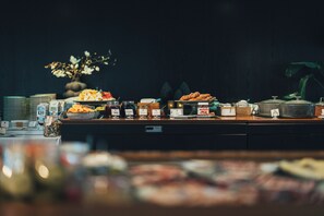 A buffet with various food items and condiments. - Hällsnäs (Mölnlycke)