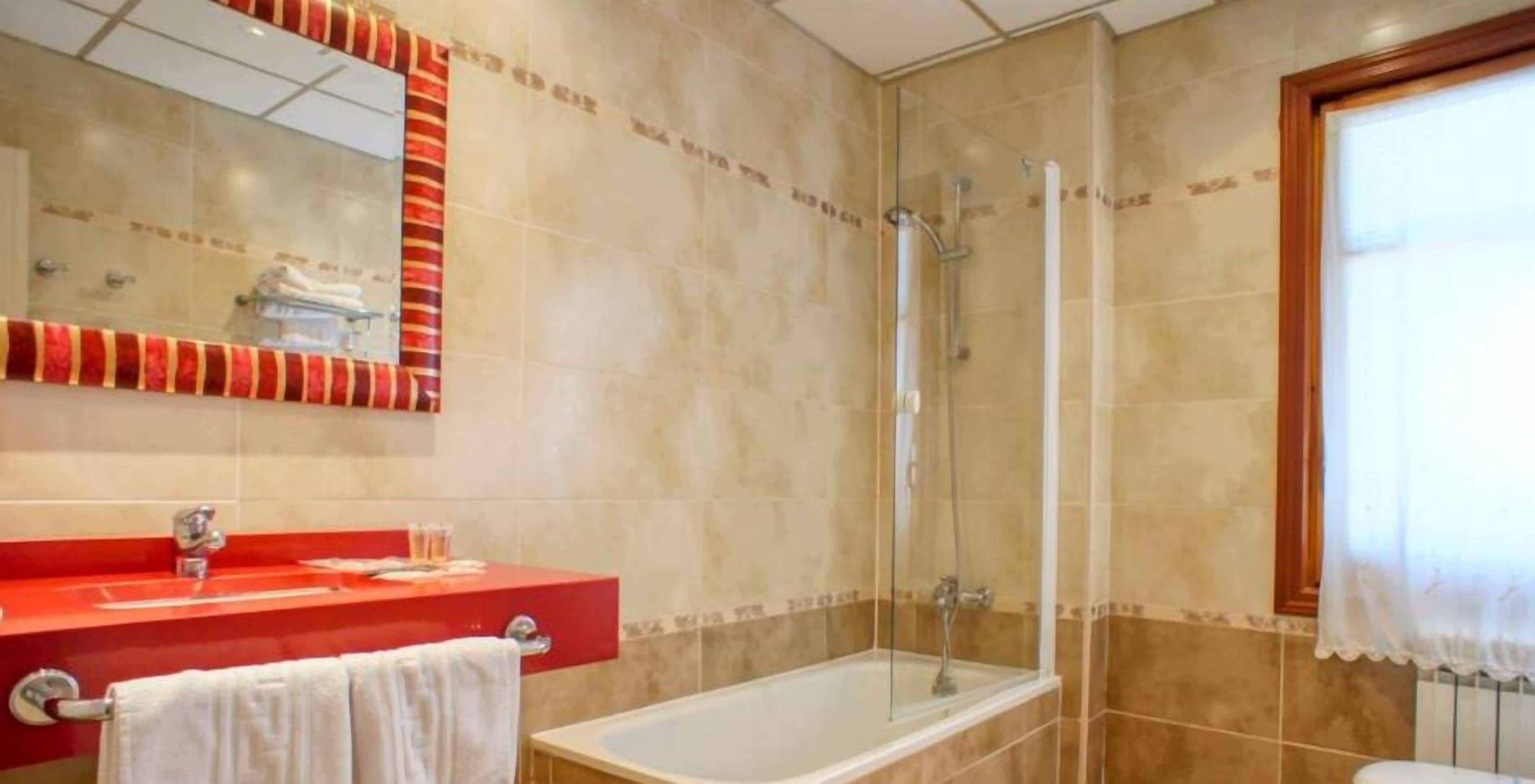 deep-soaking bathtub, hair dryer, bidet, towels