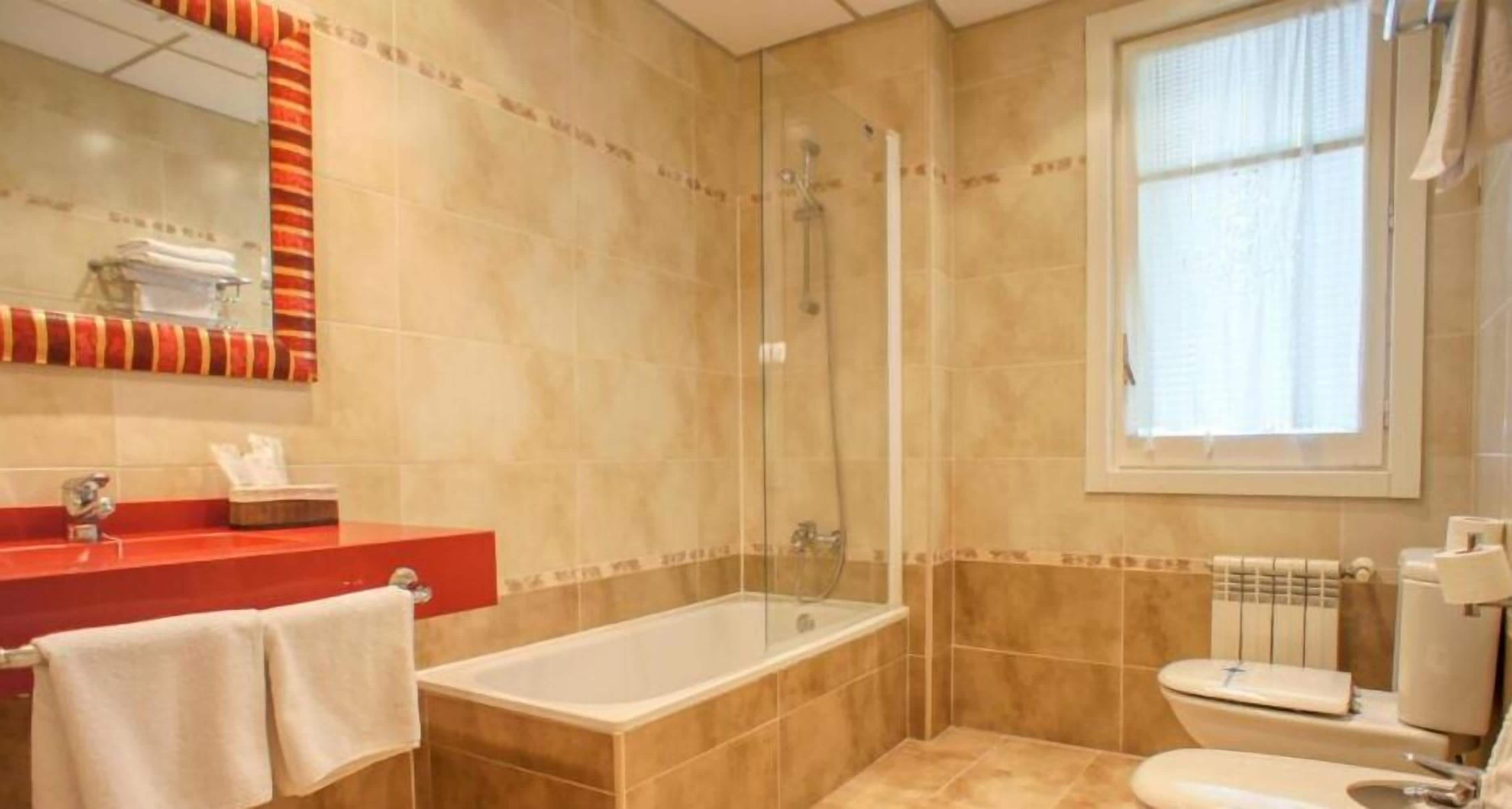 deep-soaking bathtub, hair dryer, bidet, towels